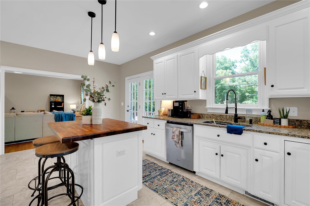 117 Winding Creek Road Anderson, SC 29621 - Photo 12 of 42 This bright kitchen features an island, ample counter space, and a view of the adjacent living area.