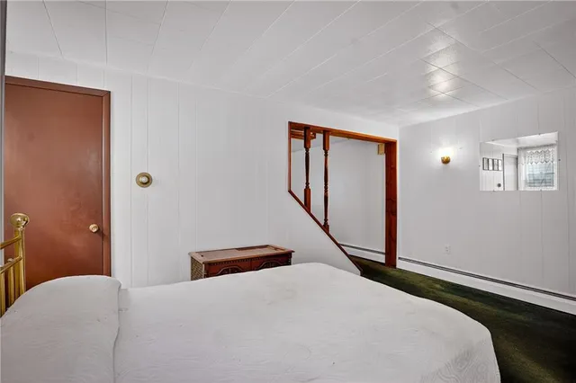 a bedroom with a bed and a dresser