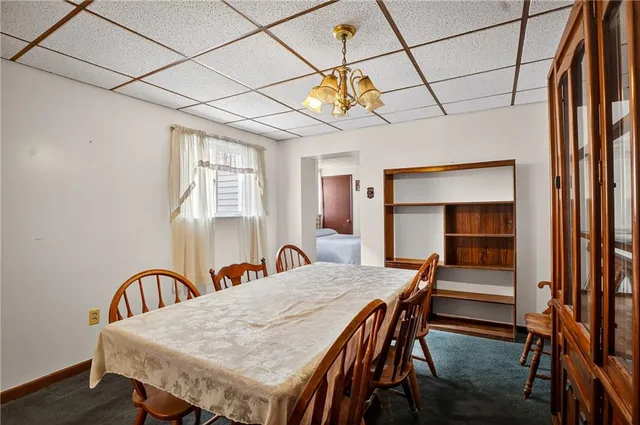 a dining room with a wooden table and chairs