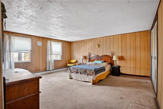 a spacious bedroom with a bed and window