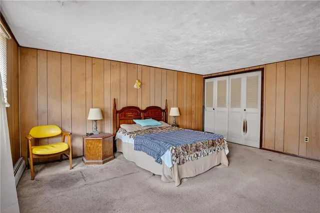 a spacious bedroom with a bed and a closet