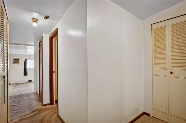 a view of hallway with wooden floor