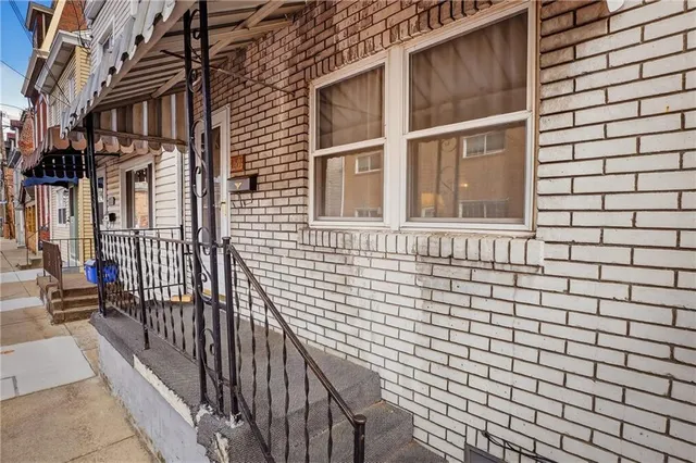 a view of a brick house with many windows