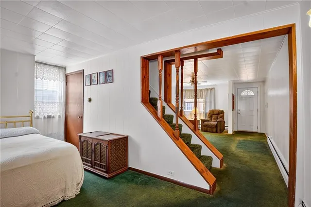 a living room with a bed furniture and a large window