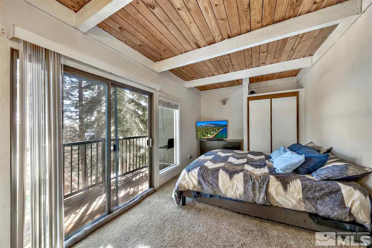331 Tramway Drive, Unit 4 Stateline, NV 89449 - Photo 13 of 18 a bedroom with furniture and a window