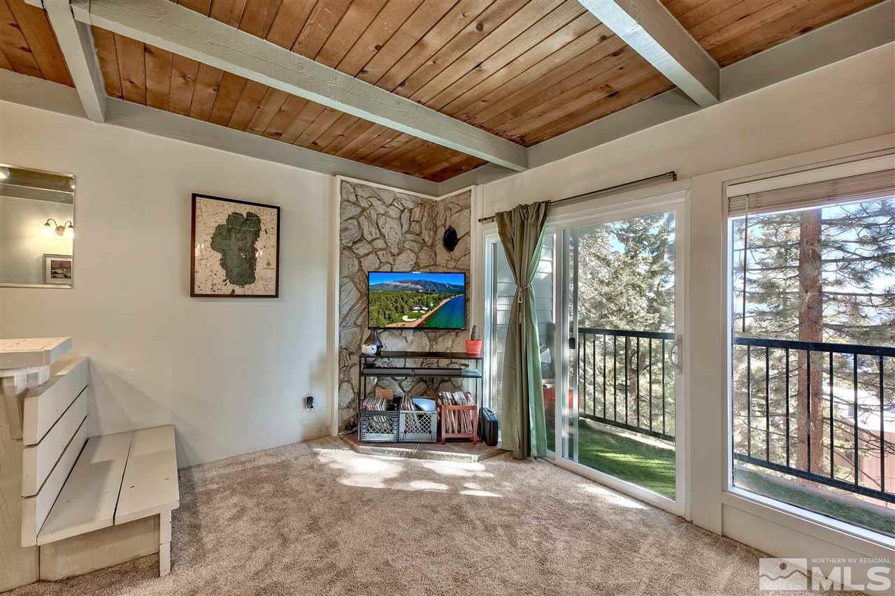 331 Tramway Drive, Unit 4 Stateline, NV 89449 - Photo 16 of 18 a view of an empty room with a fireplace and a window