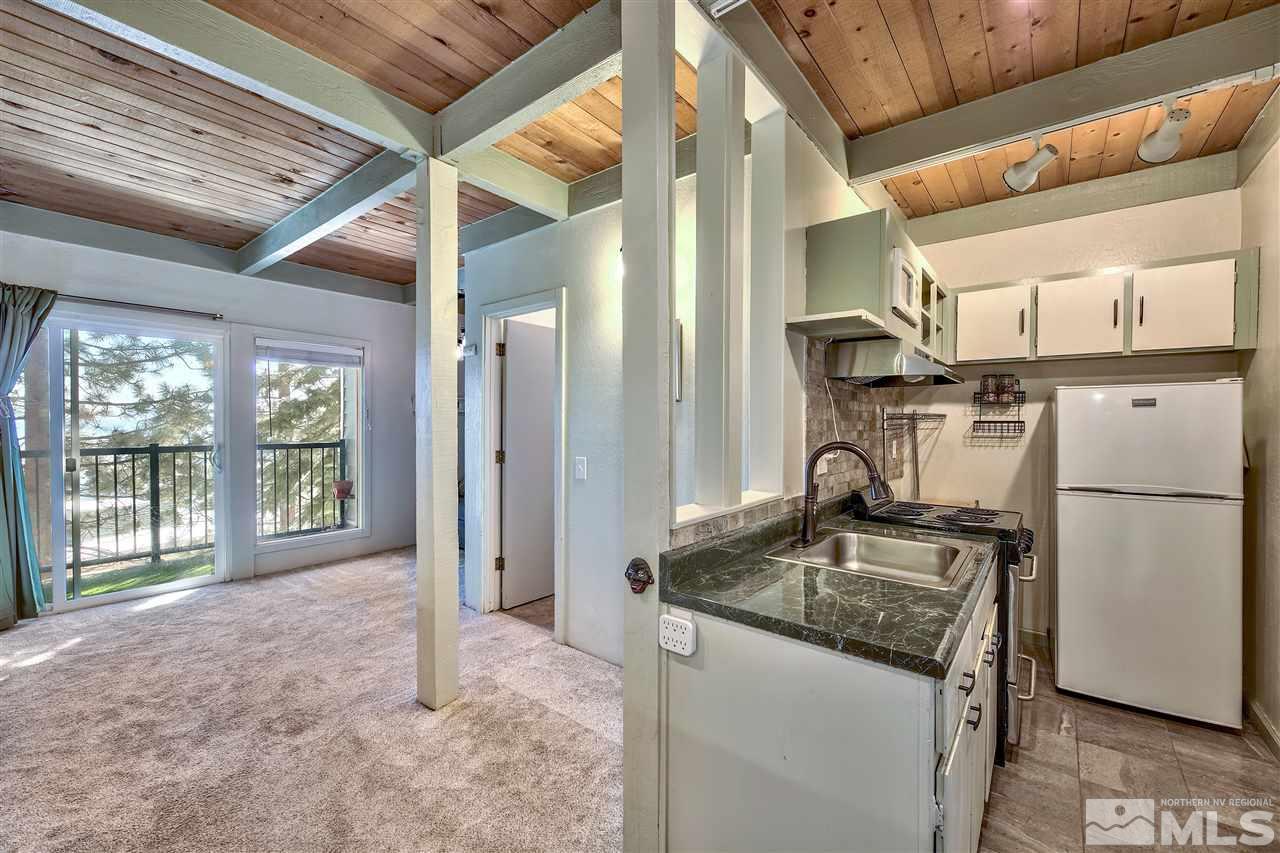 331 Tramway Drive, Unit 4 Stateline, NV 89449 - Photo 8 of 18 a kitchen with refrigerator a sink and a large window