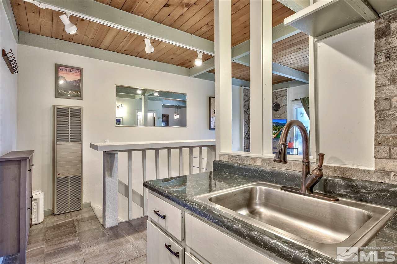 331 Tramway Drive, Unit 4 Stateline, NV 89449 - Photo 10 of 18 a kitchen with a sink a refrigerator and a window