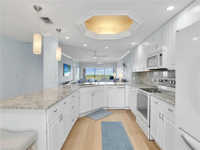 a kitchen with a sink cabinets and window