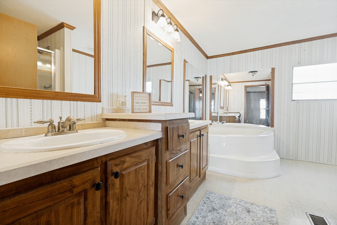 207 Vivian Road Onalaska, TX 77360 - Photo 21 of 34 a bathroom with a granite countertop sink mirror and bathtub