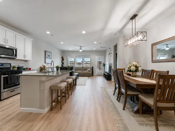 a kitchen with counter top space a sink appliances and cabinets