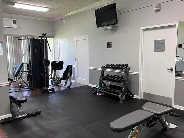 a room with lots of potted plants and a chandelier