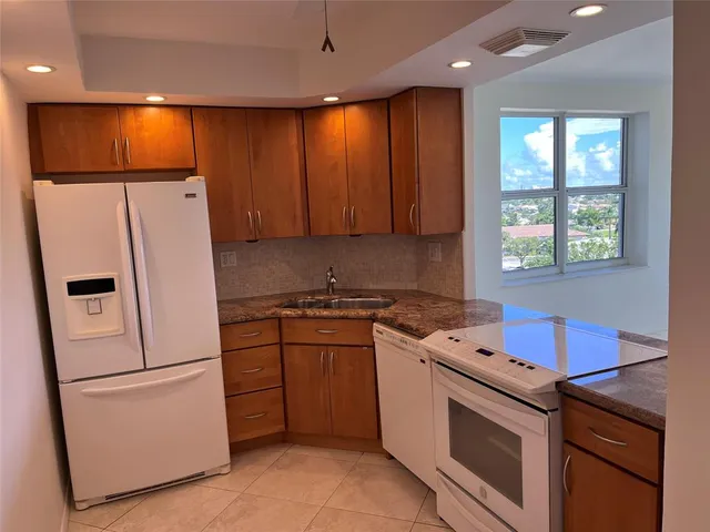 a white refrigerator freezer sitting inside of a kitchen