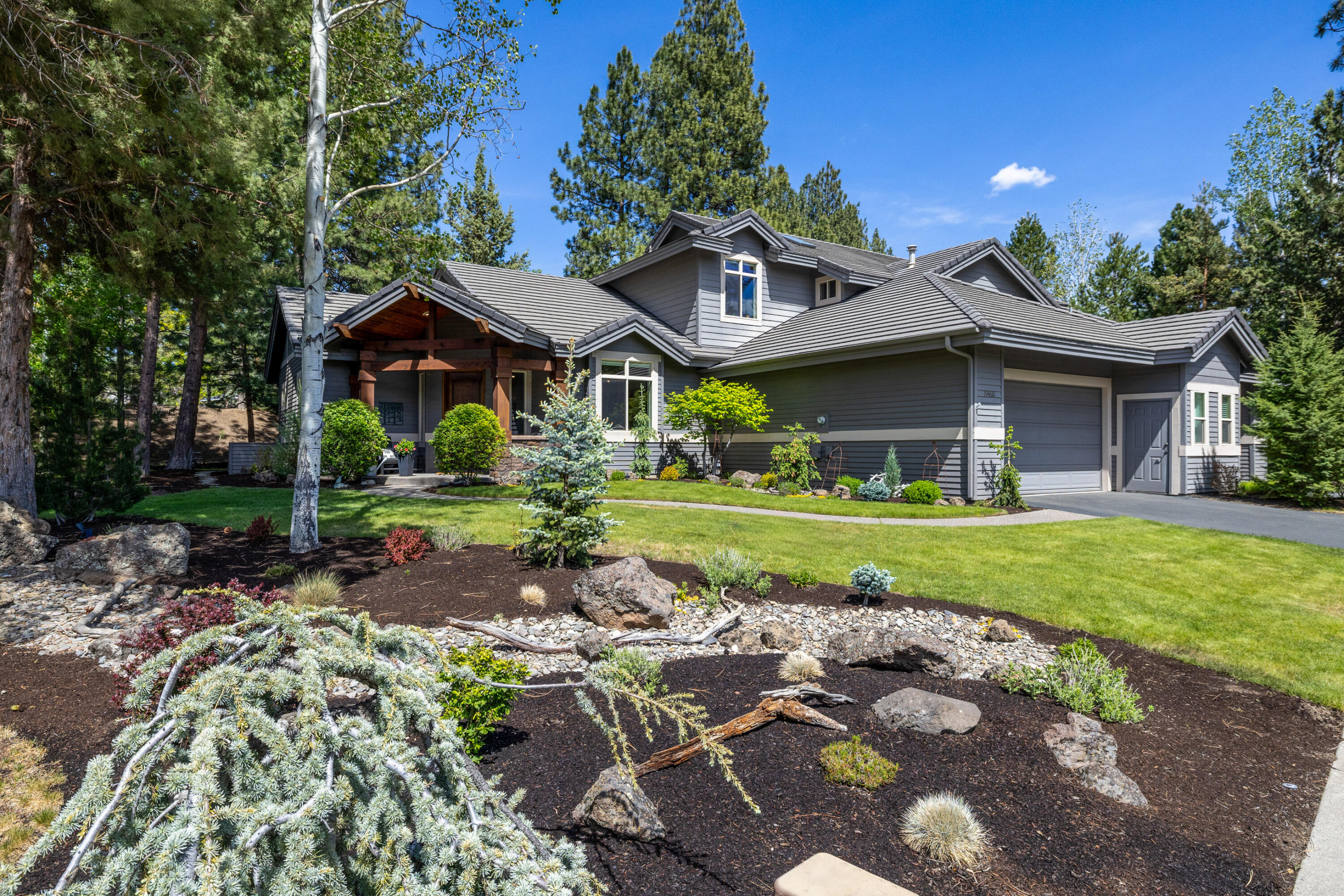 19460 Chip Shot Lane Bend, OR 97702 - Photo 1 of 56 a front view of a house with a garden