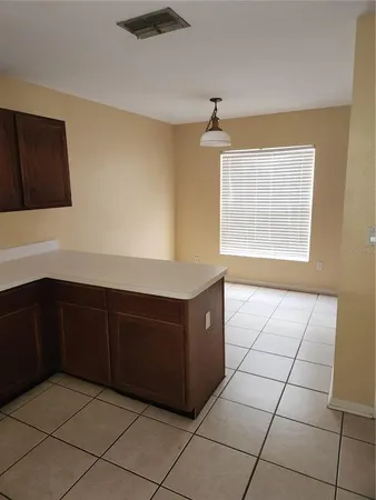 a kitchen with a cabinets and window