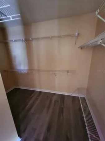 an empty room with wooden floor