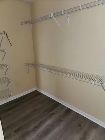 a view of a room with wooden floor