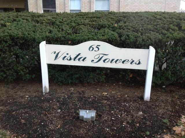 65 Glenbrook Road, Unit 8G Stamford, CT 06902 - Photo 1 of 1 a view of a wooden house with a yard
