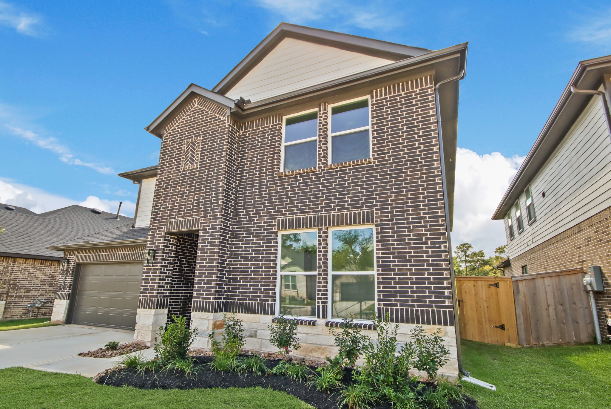 259 Springfield Terrace Drive Conroe, TX 77304 - Photo 2 of 14 a front view of a house with garden