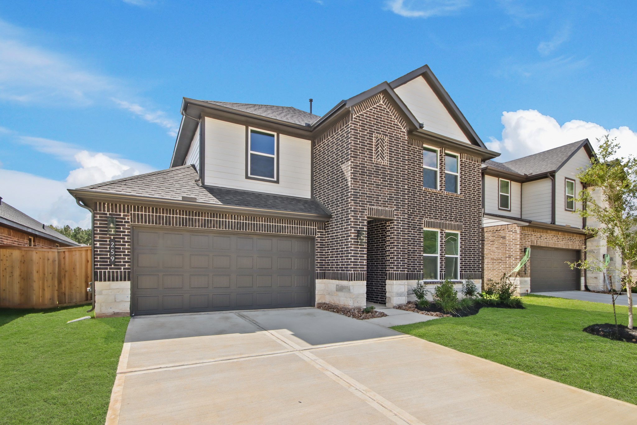259 Springfield Terrace Drive Conroe, TX 77304 - Photo 3 of 14 a front view of a house with a garden and yard