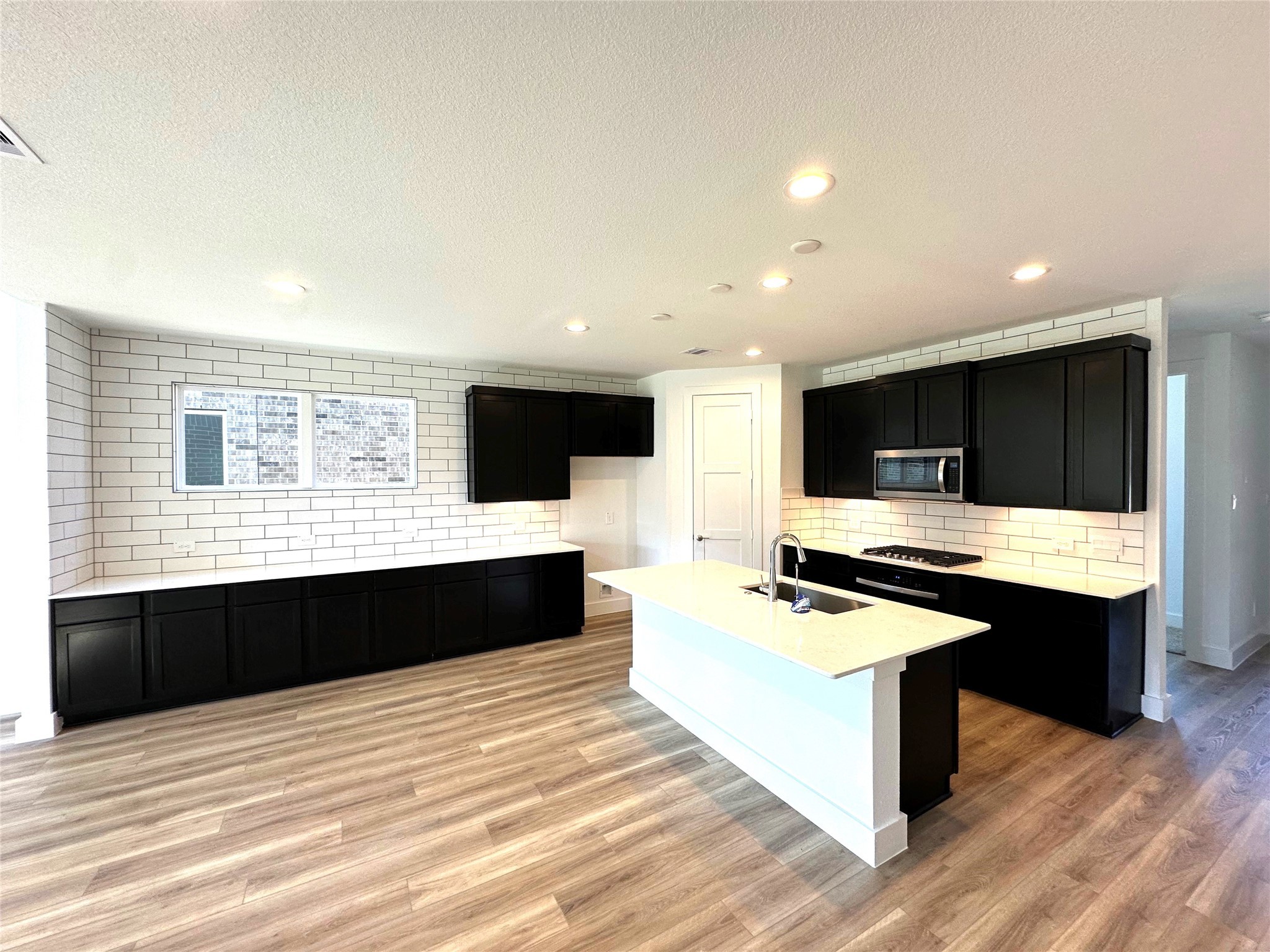 259 Springfield Terrace Drive Conroe, TX 77304 - Photo 4 of 14 a kitchen with a stove and a sink