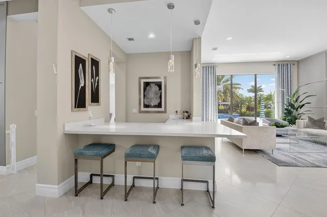 a kitchen with stainless steel appliances granite countertop a sink a stove and a refrigerator