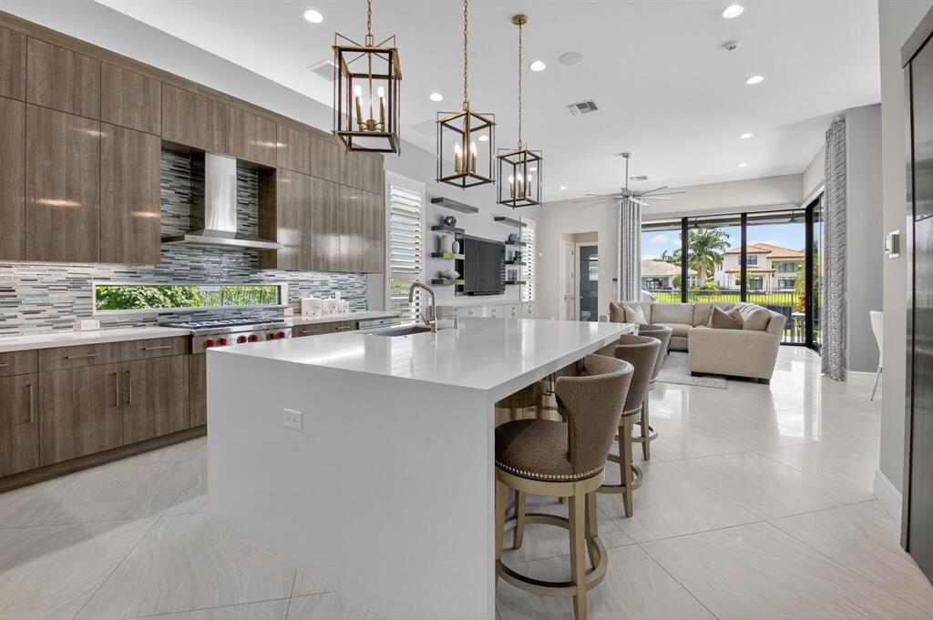 9294 Biaggio Road Boca Raton, FL 33496 - Photo 15 of 80 a kitchen with stainless steel appliances granite countertop a sink a stove and a refrigerator
