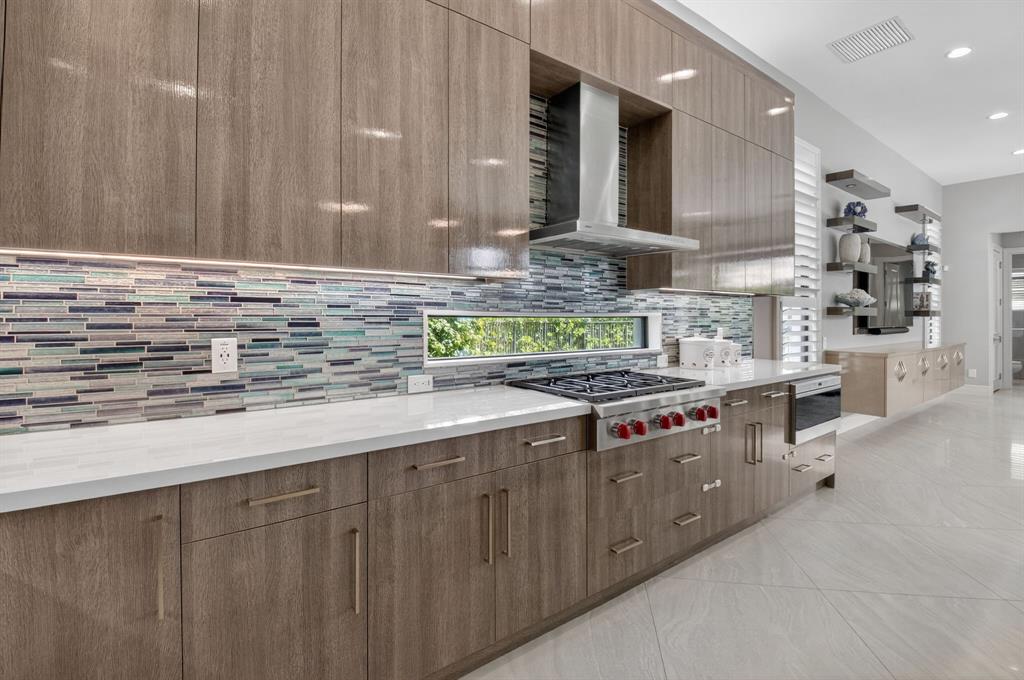 9294 Biaggio Road Boca Raton, FL 33496 - Photo 19 of 80 a kitchen with stainless steel appliances granite countertop a stove a sink and a white cabinets