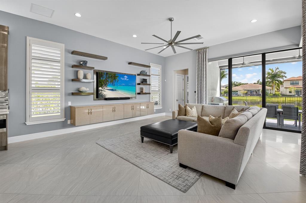 9294 Biaggio Road Boca Raton, FL 33496 - Photo 24 of 80 a living room with furniture flat screen tv and a large window