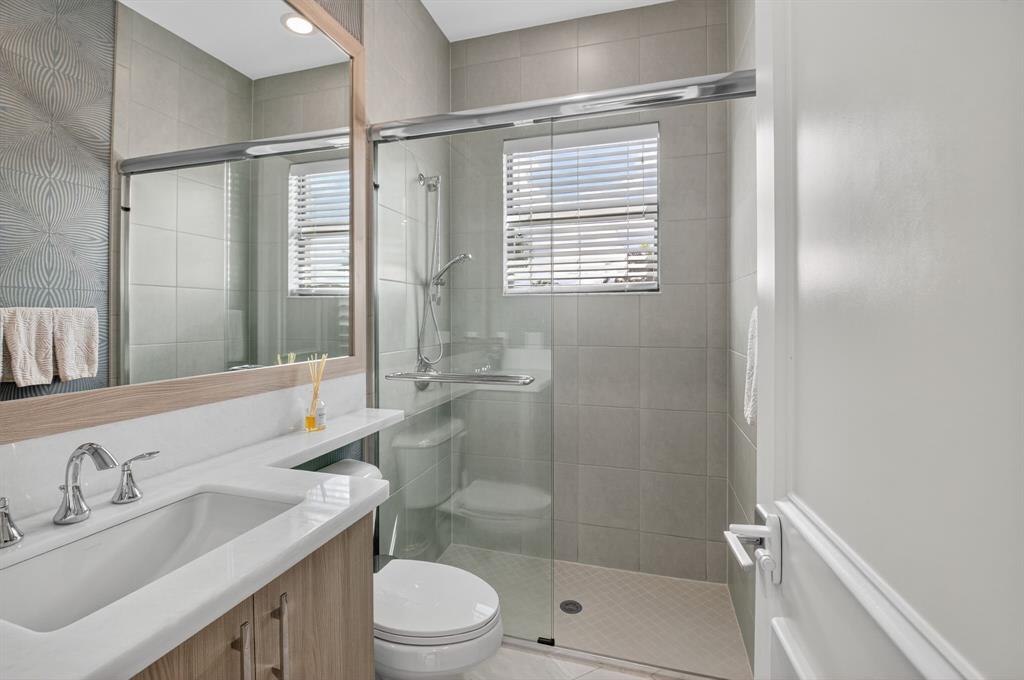 9294 Biaggio Road Boca Raton, FL 33496 - Photo 27 of 80 a bathroom with a sink toilet and shower