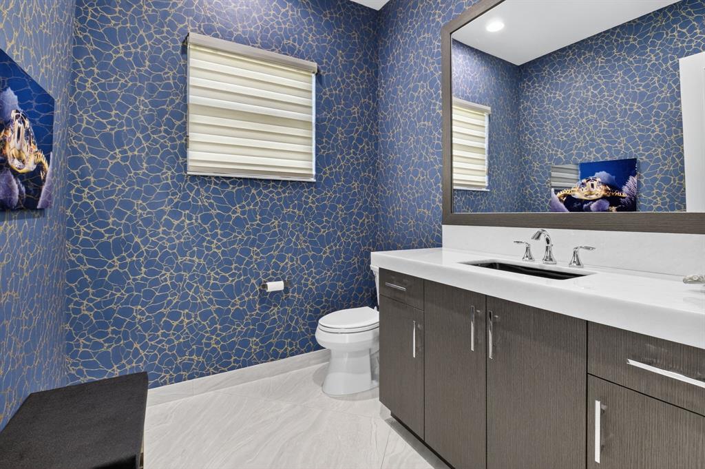 9294 Biaggio Road Boca Raton, FL 33496 - Photo 29 of 80 a bathroom with a toilet a sink and mirror