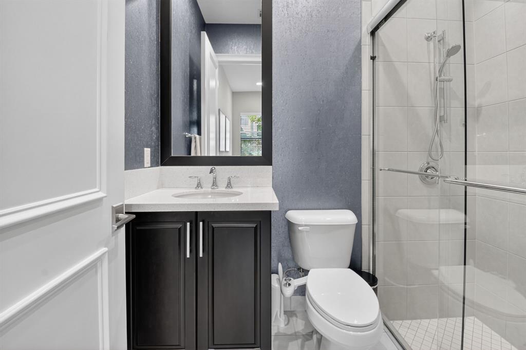 9294 Biaggio Road Boca Raton, FL 33496 - Photo 32 of 80 a bathroom with a toilet a sink and mirror