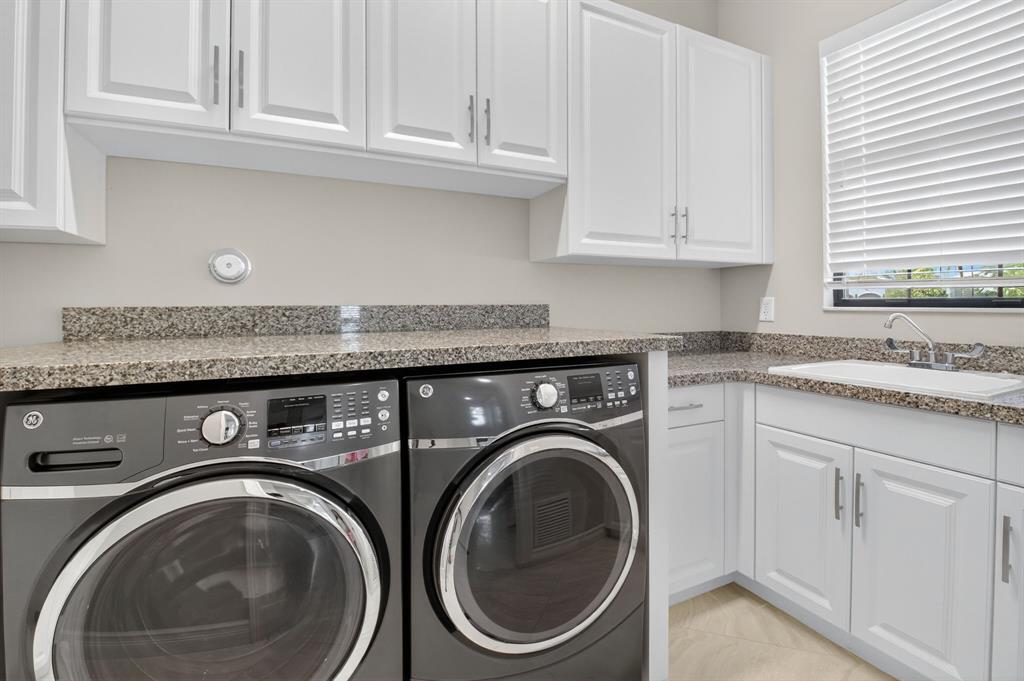 9294 Biaggio Road Boca Raton, FL 33496 - Photo 33 of 80 a utility room with sink dryer and washer