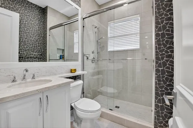 a large bathroom with a double vanity sink a mirror and a bathtub