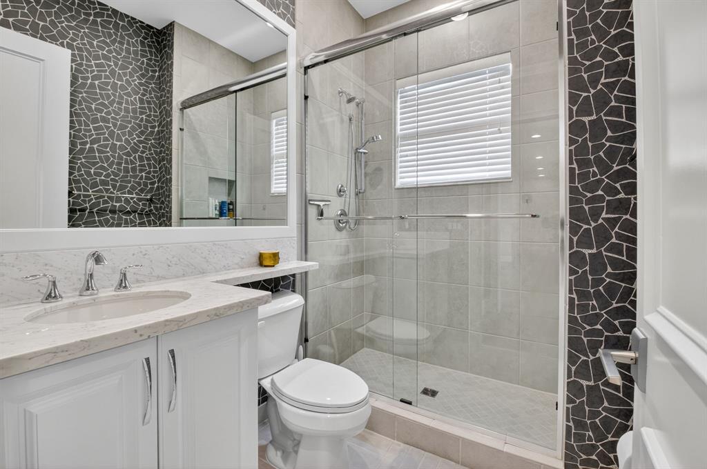 9294 Biaggio Road Boca Raton, FL 33496 - Photo 37 of 80 a bathroom with a sink a toilet and shower
