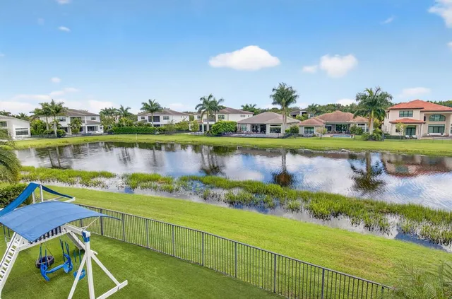a view of a lake with a house in the background