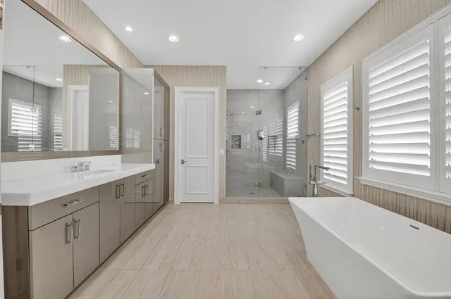 an aerial view of a house with a garden and lake view