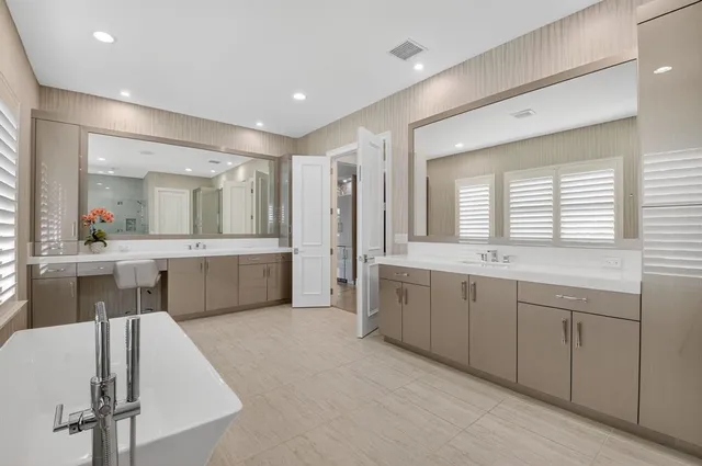 an aerial view of residential houses with outdoor space and lake view