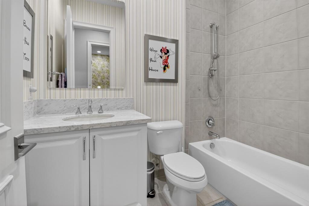 9294 Biaggio Road Boca Raton, FL 33496 - Photo 54 of 80 a bathroom with a granite countertop sink a toilet and a bathtub