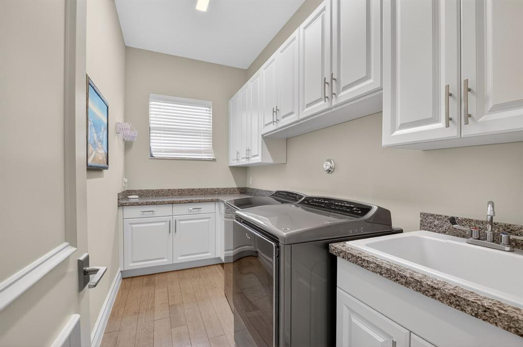 9294 Biaggio Road Boca Raton, FL 33496 - Photo 55 of 80 a kitchen with granite countertop a sink stove and cabinets