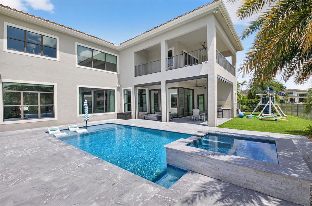 9294 Biaggio Road Boca Raton, FL 33496 - Photo 58 of 80 a view of a house with a swimming pool and a porch