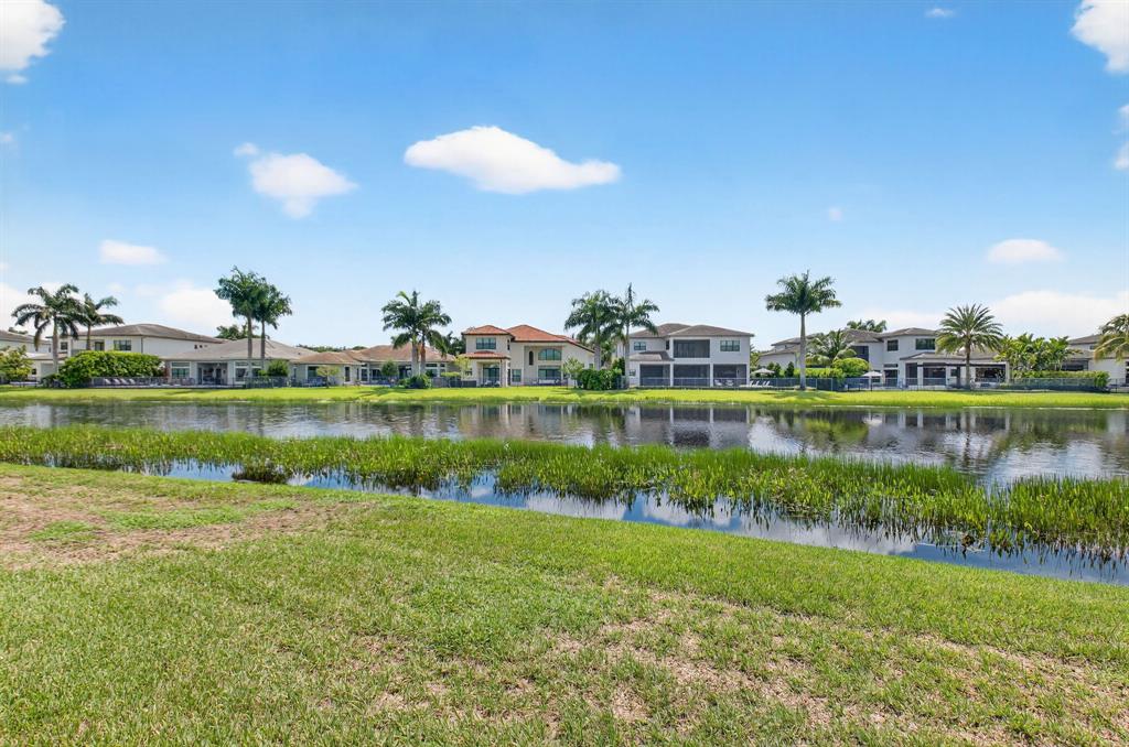 9294 Biaggio Road Boca Raton, FL 33496 - Photo 66 of 80 a view of a lake with a house in the background