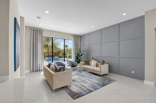 a living room with furniture and a potted plant