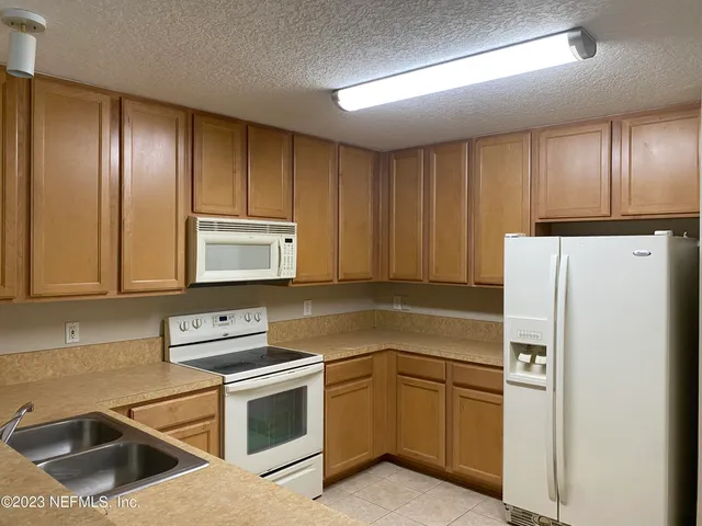 a kitchen with a refrigerator sink and microwave