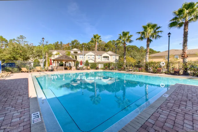 a view of a swimming pool with a lounge chairs