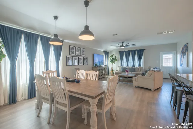 a view of a dining room with furniture window and wooden floor