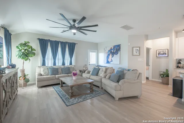 a living room with furniture and a large window