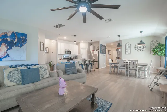a living room with furniture and kitchen view