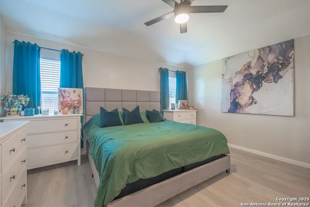 a bedroom with a large bed and a chandelier