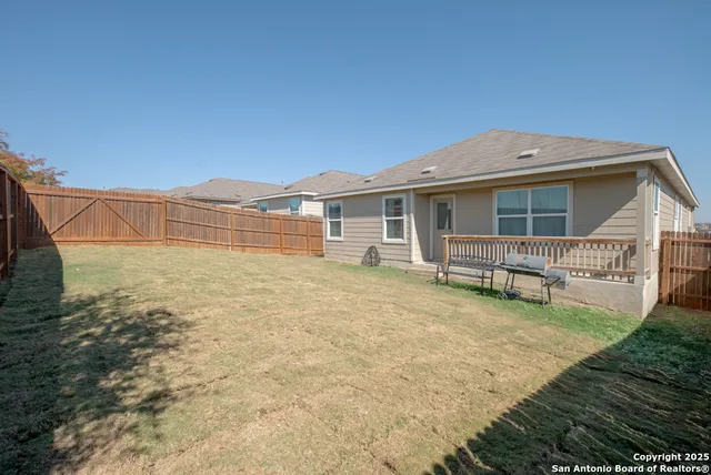 a view of a house with a yard and sitting area